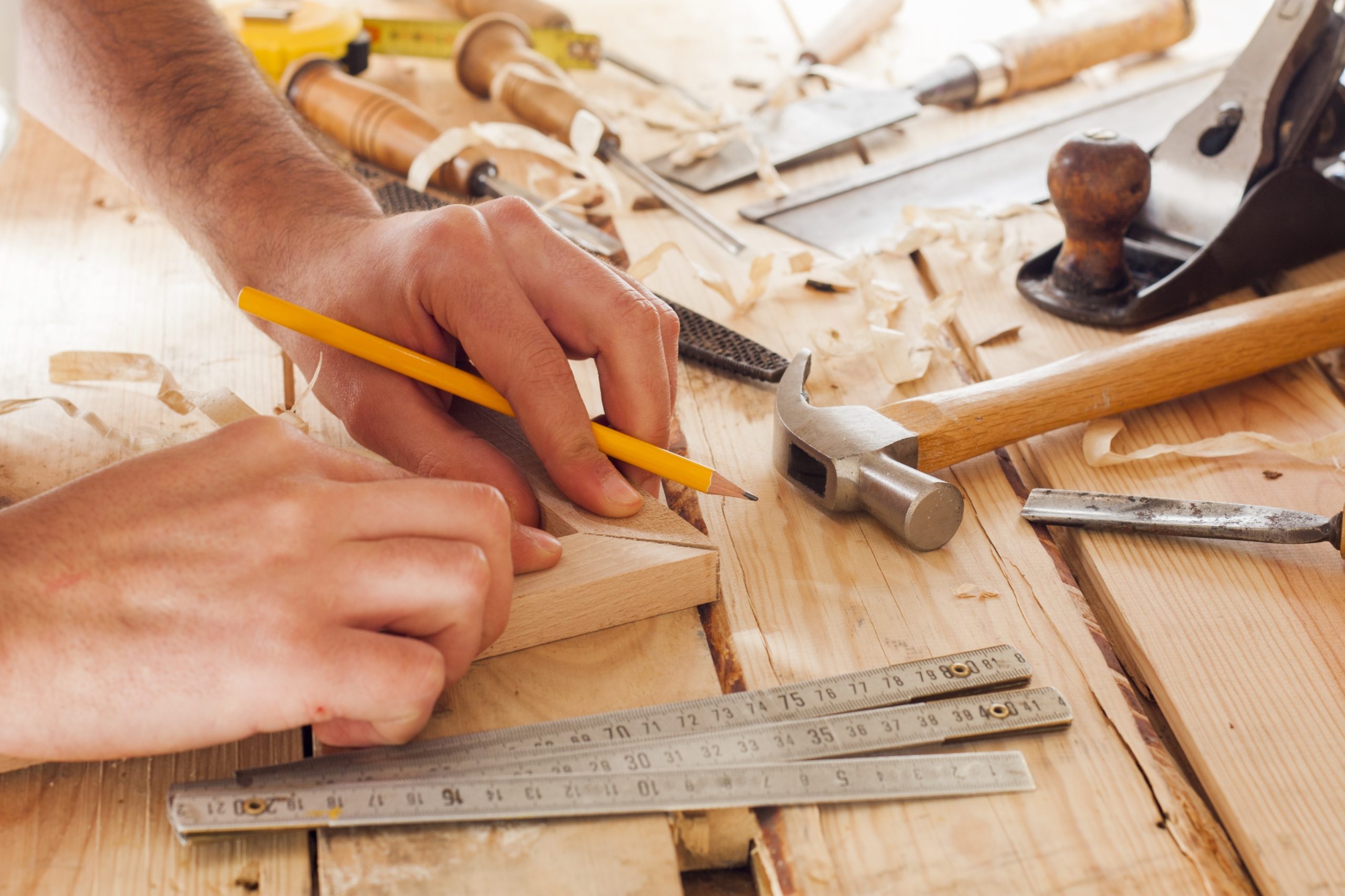 carpenter working,hammer,meter and screw-driver on construction background