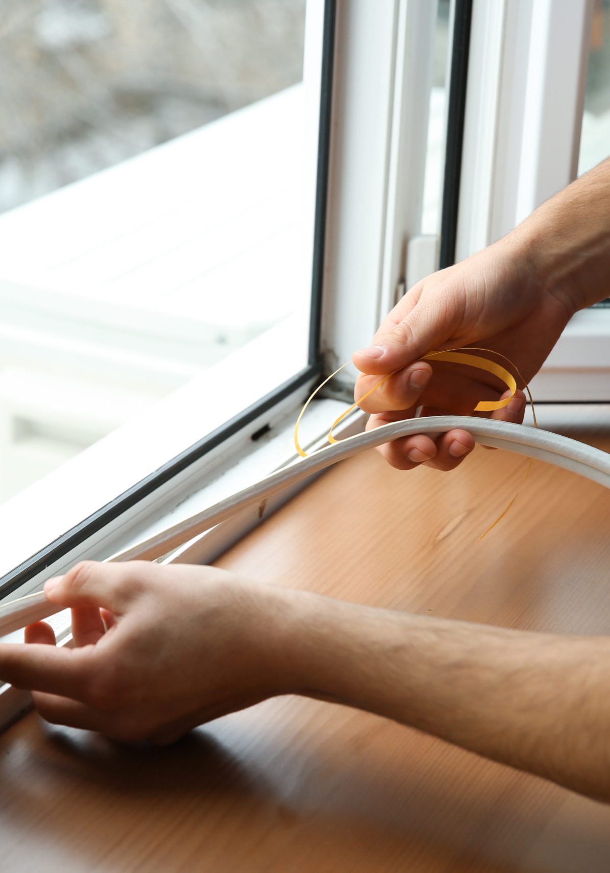 Young worker installing window in flat